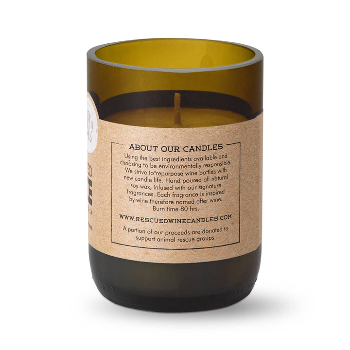 Candle in a repurposed wine bottle with a label on a white background