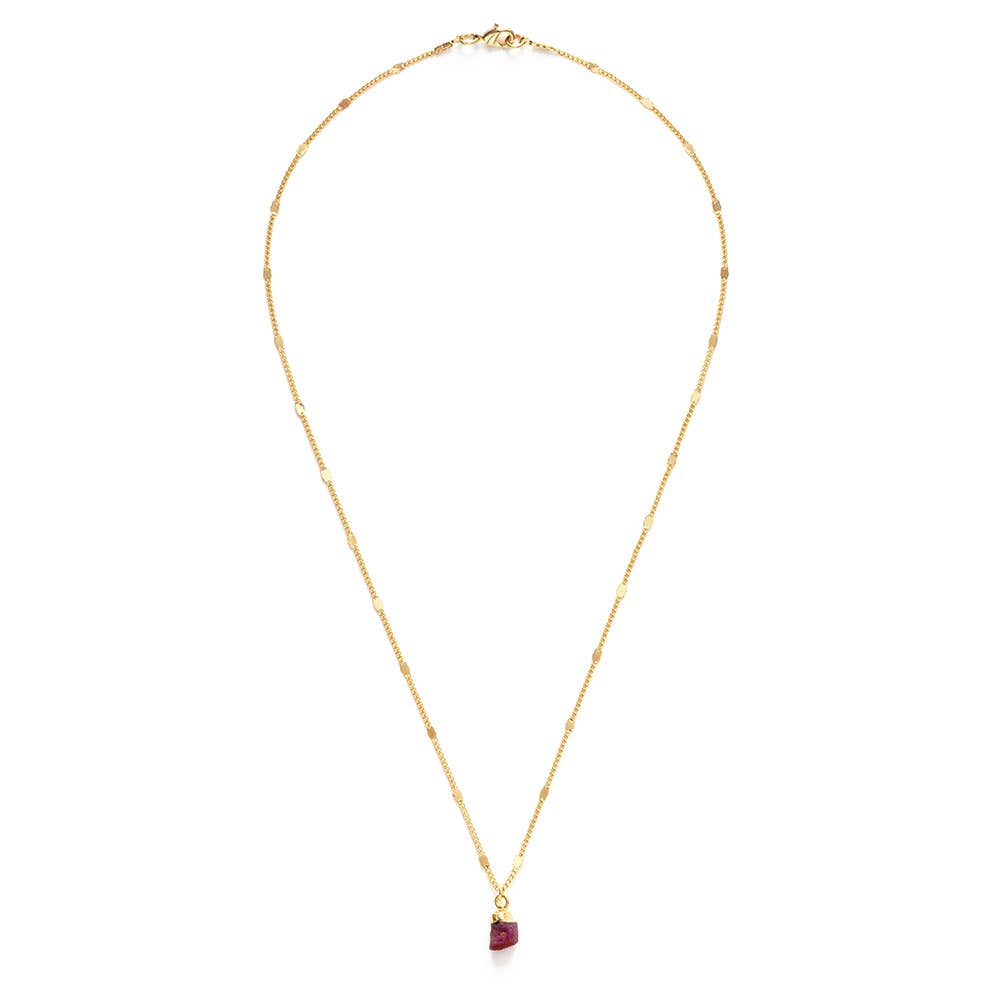 Gold necklace with a red gemstone pendant on a white background