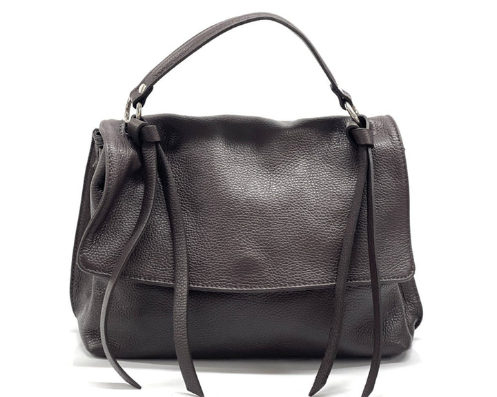 A dark brown pebbled leather handbag with a top handle and long hanging ties, photographed against a plain white background.