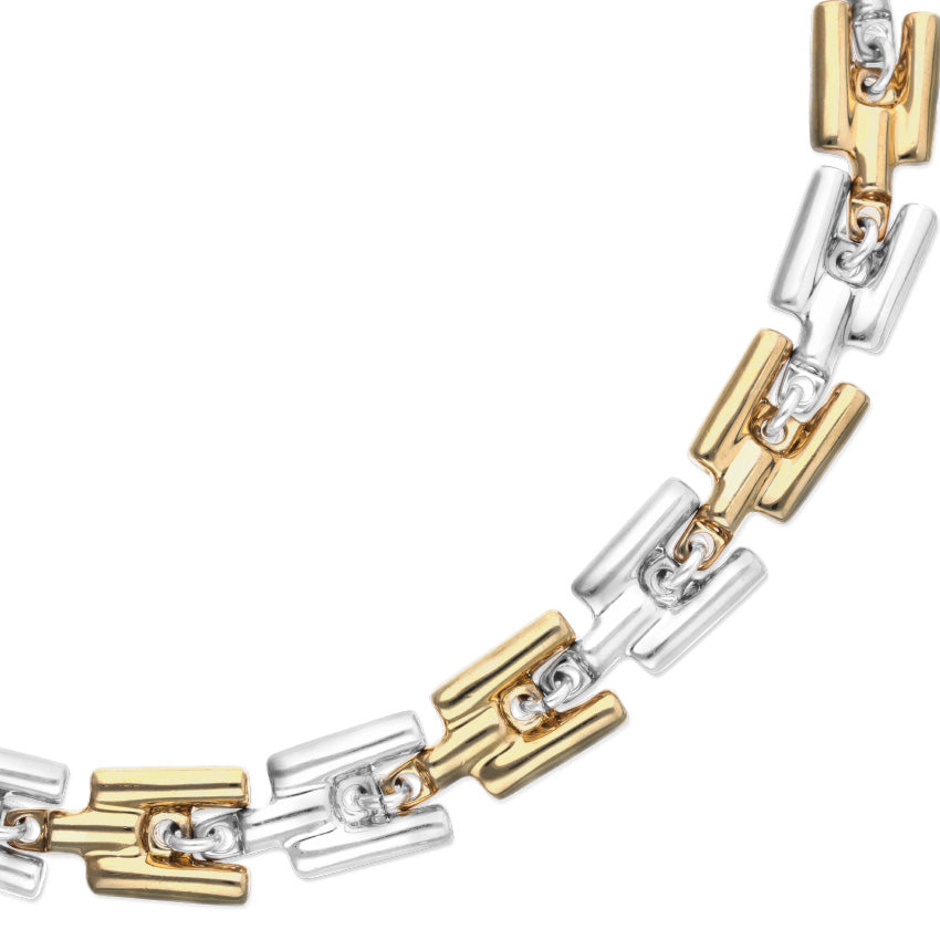 Bracelet with gold and silver links on a white background