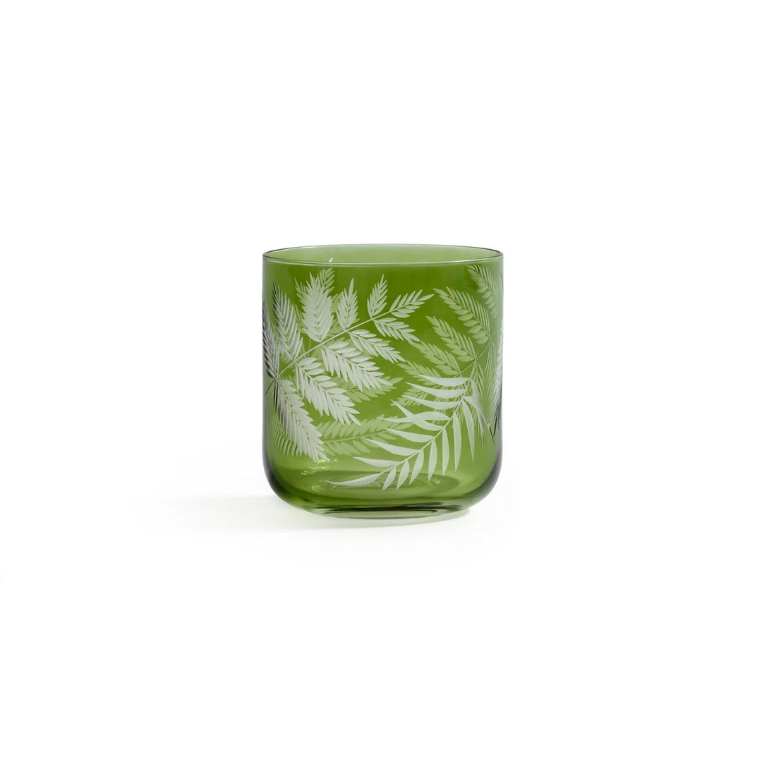 Green glass tumbler with white leaf pattern on a white background | Artisans