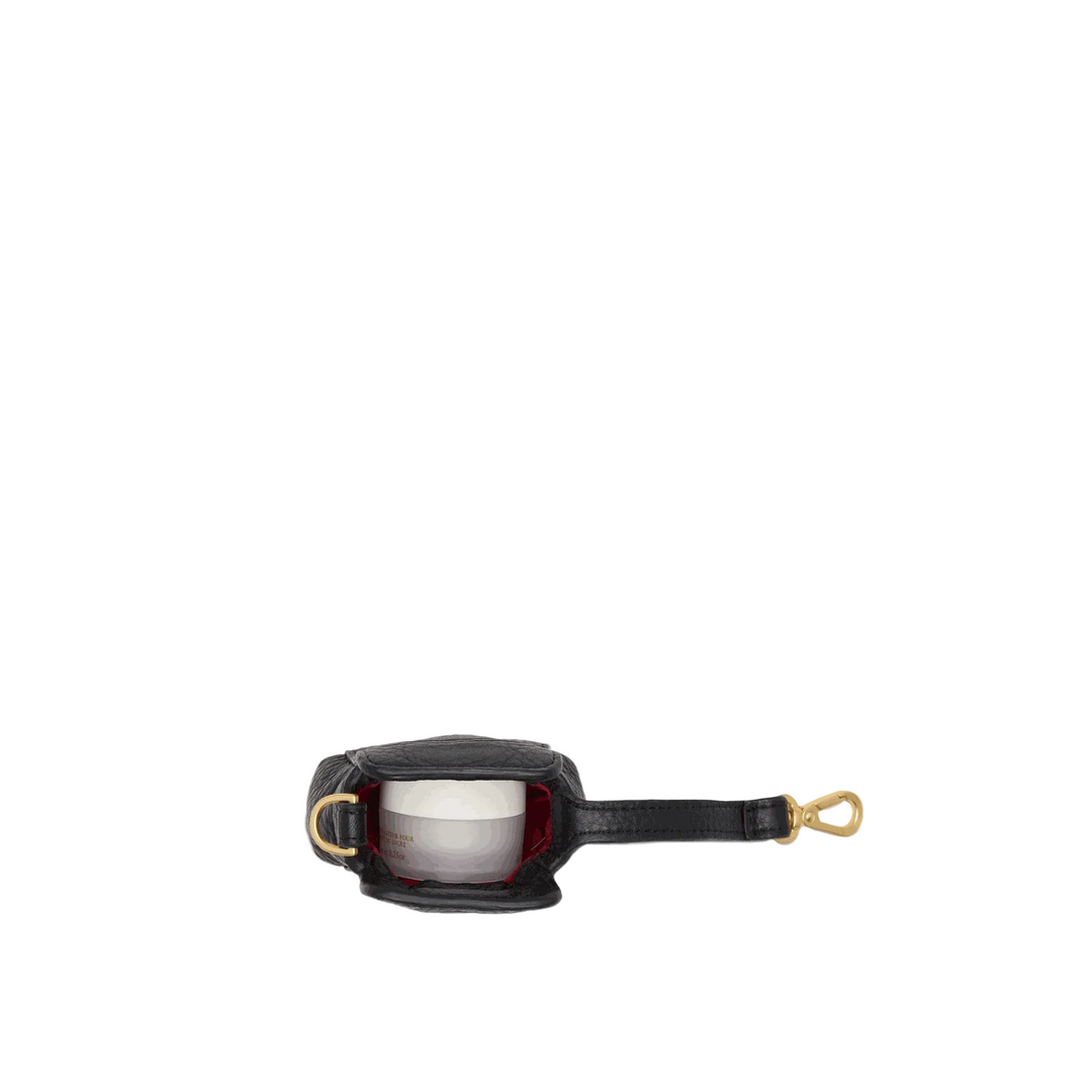 A small black leather pouch with gold-tone hardware and a strap, shown open against a plain light gray background.