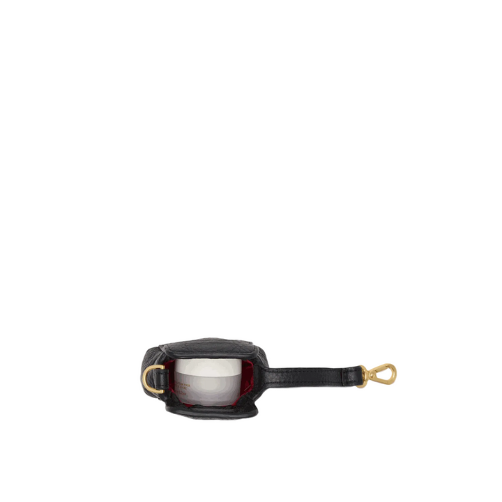 A small black leather pouch with gold-tone hardware and a strap, shown open against a plain light gray background.