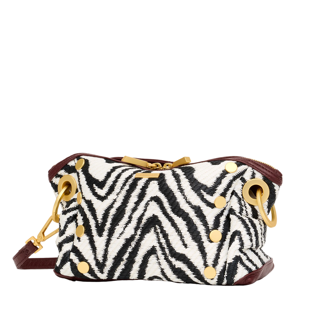 Zebra patterned handbag with gold accents on a white background