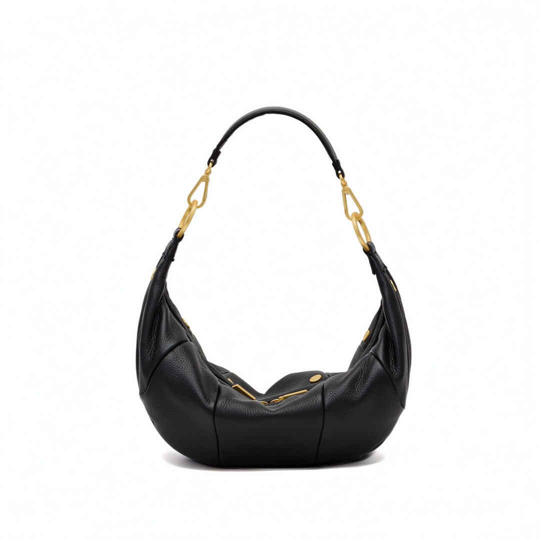 A black pebbled leather crescent-shaped shoulder bag with gold-tone hardware and a curved shoulder strap, shown on a plain white background.