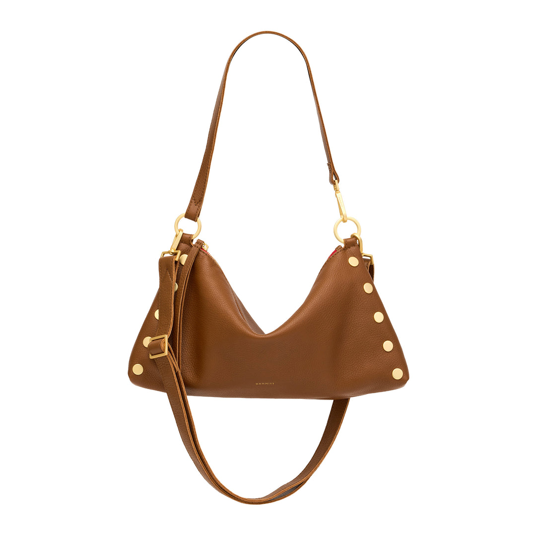 A brown leather crescent-shaped shoulder bag with gold-tone hardware, stud accents, and a long shoulder strap, shown against a plain white background.