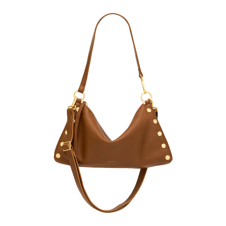 A brown leather crescent-shaped shoulder bag with gold-tone hardware, stud accents, and a long shoulder strap, shown against a plain white background.