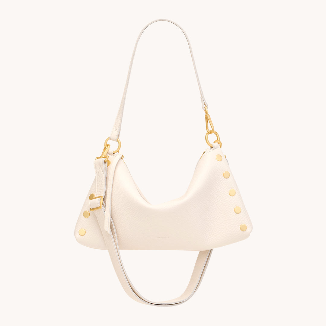 An off-white pebbled leather shoulder bag with gold-tone hardware and decorative gold studs, shown against a solid off-white background.