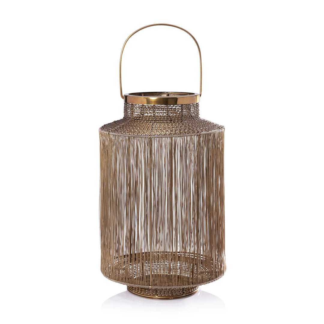 A decorative metal lantern with a cylindrical body, vertical slatted fringe texture, a top handle, and a flared base, shown on a clean white background.