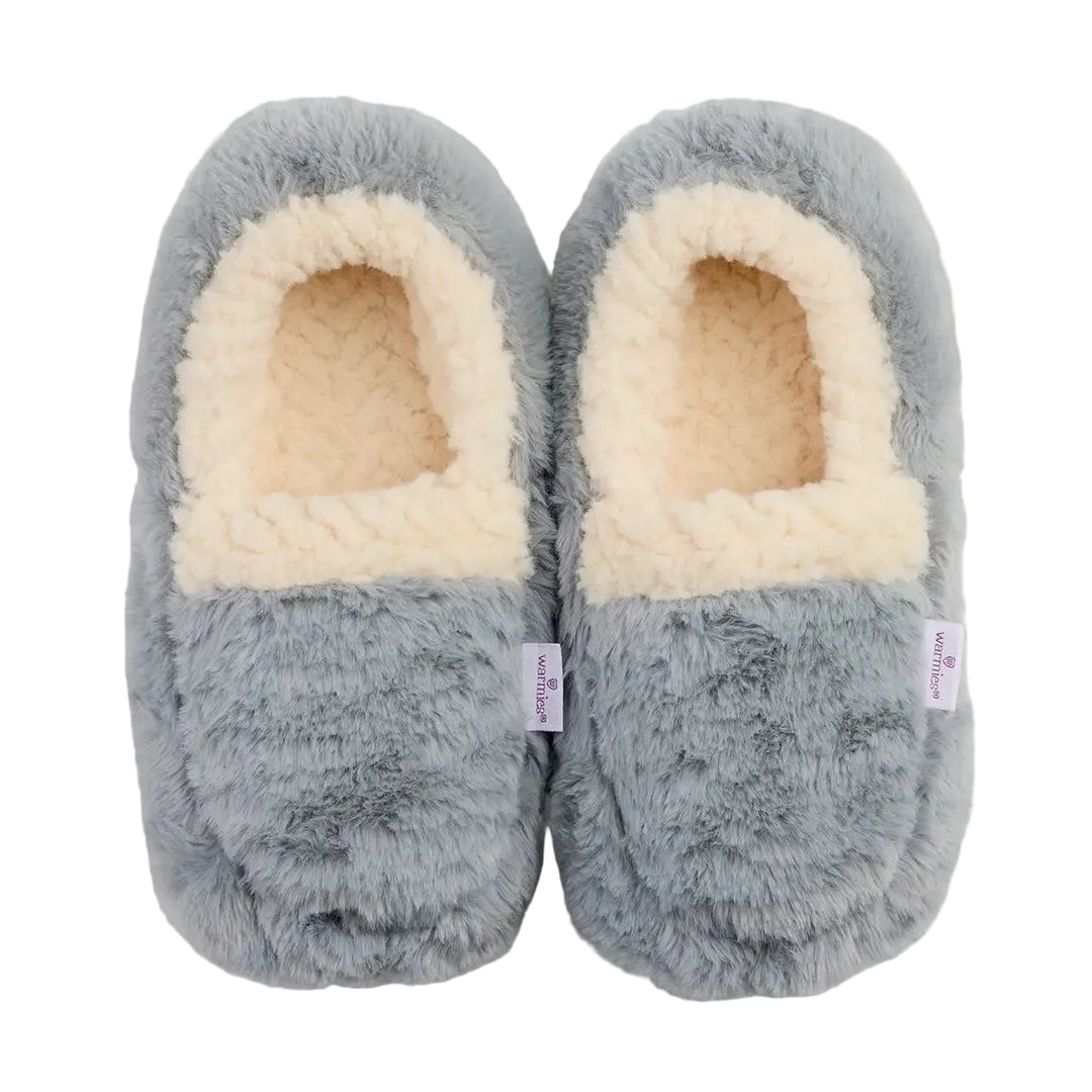 A pair of plush slip-on slippers in a dusty blue-gray color with a cream-colored sherpa lining, shown from a top-down view on a light off-white background.