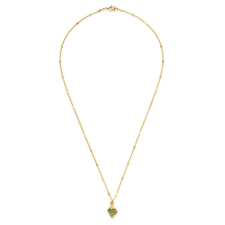 Gold necklace with a green heart pendant on a white background