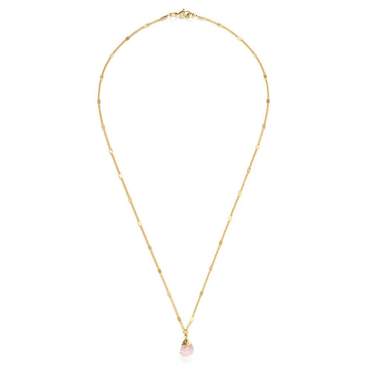 Gold necklace with a pink pendant on a white background