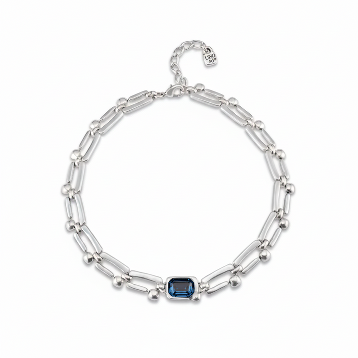 Silver bracelet with a blue gemstone on a white background